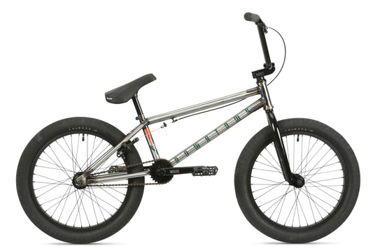 The Haro Bikes Downtown DLX BMX bike, silver with black handlebars, seat, and tires, is shown from the side on a white background.