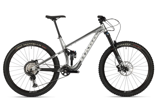 Introducing the Haro Bikes Daley Alloy LTD 2, a silver mountain bike with Fox Suspension for smooth rides. It features disc brakes and thick treaded tires. Displayed side-on against a white background, its built for your next adventure.