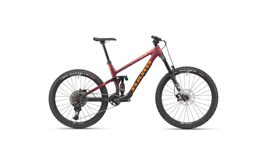 The Greer Carbon 1 by Haro Bikes is a maroon enduro bike with Fox suspension, black wheels, disc brakes, and bold orange branding.