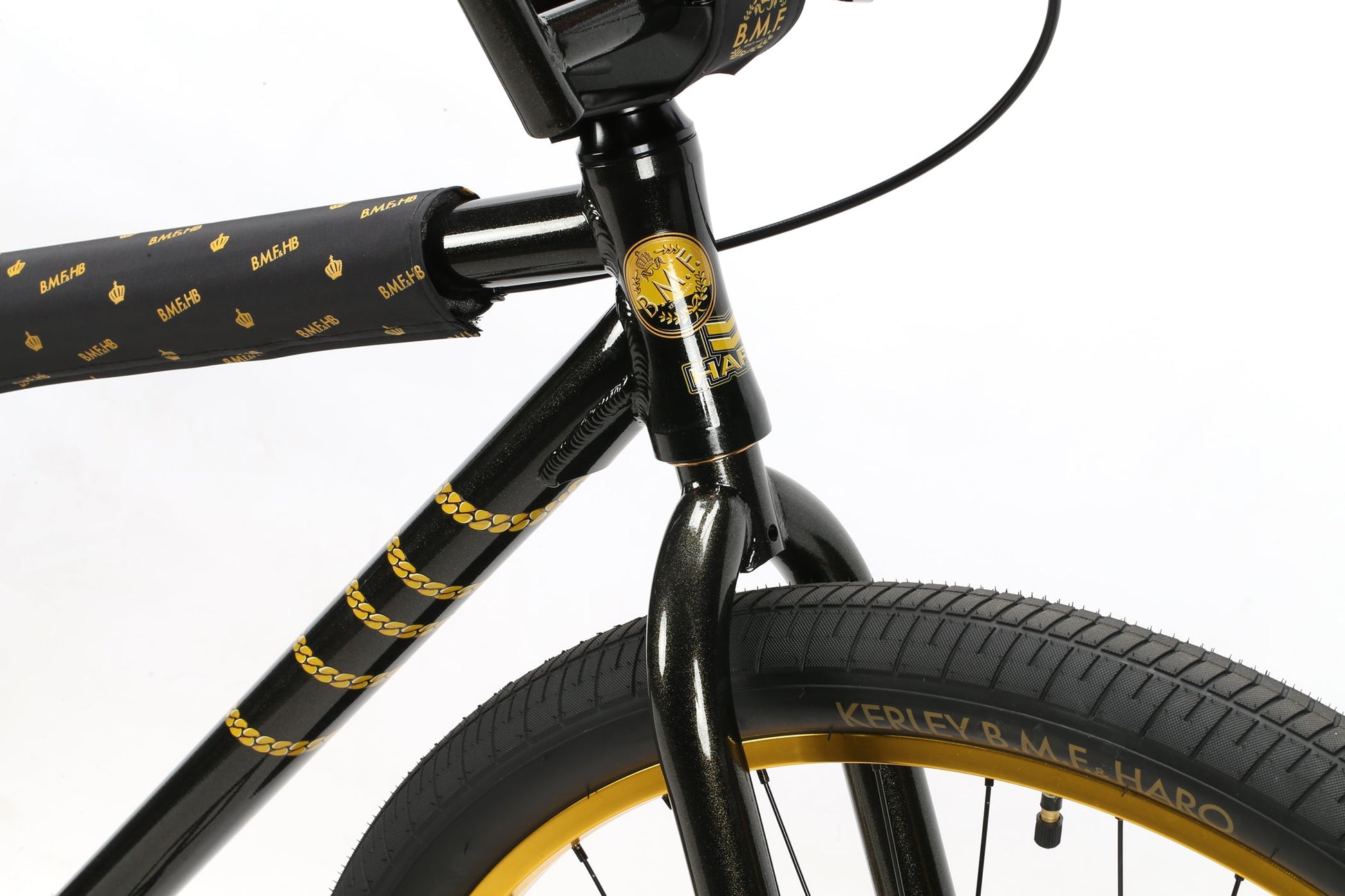 Close-up of Chad Kerleys black BMX bike with gold accents, a logo on the head tube, and Haro Bikes B.M.F branding on the front tire.