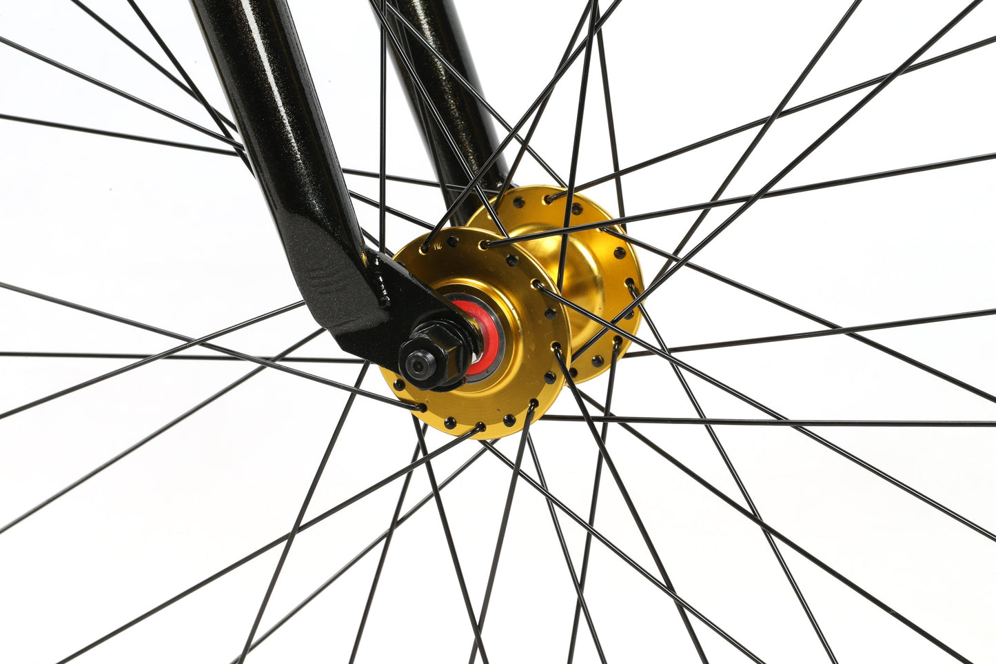 Close-up of Haro Bikes B.M.F BMX wheel with a golden hub, black spokes, and a sleek fork on a white backdrop.