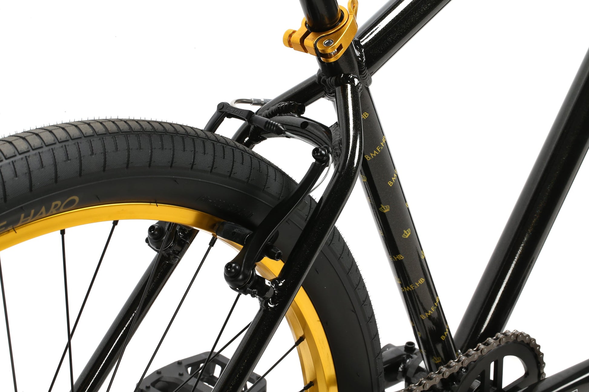 Close-up of the Haro Bikes B.M.F black BMX frame with yellow accents, showcasing the rear wheel and brake caliper—ideal for ride-outs.