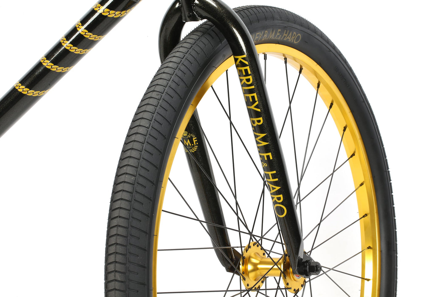 Close-up of a BMX fork with gold accents. Tires branded Kerfey B.M.F Haro Bikes, ideal for Chad Kerley-inspired ride-outs.