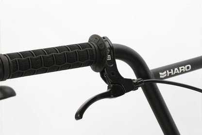 Close-up of a Leucadia handlebar by Haro Bikes with strong textured grip and brake lever, featuring its sturdy Hi-Ten steel frame.