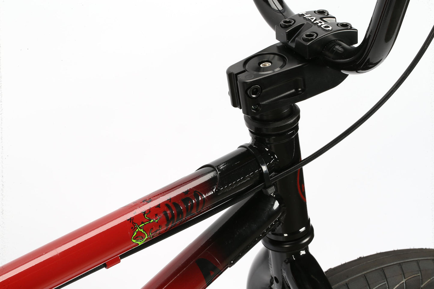 Close-up of a Leucadia red and black BMX frame by Haro Bikes with Hi-Ten-Stahlrahmen handlebars on a white background.