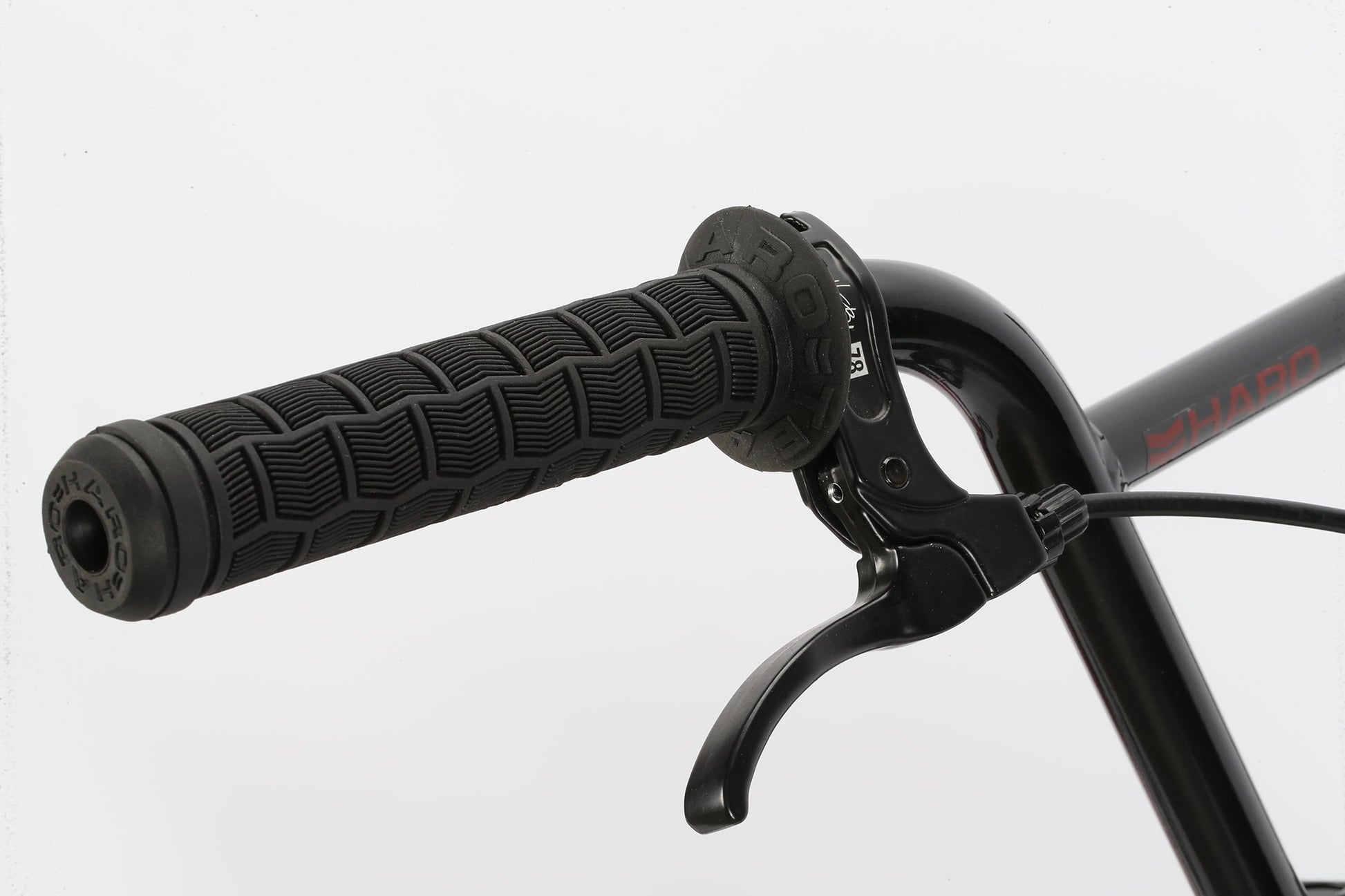 Close-up of a Leucadia handlebar by Haro Bikes, featuring textured black grips and hand brake lever against a plain white background.