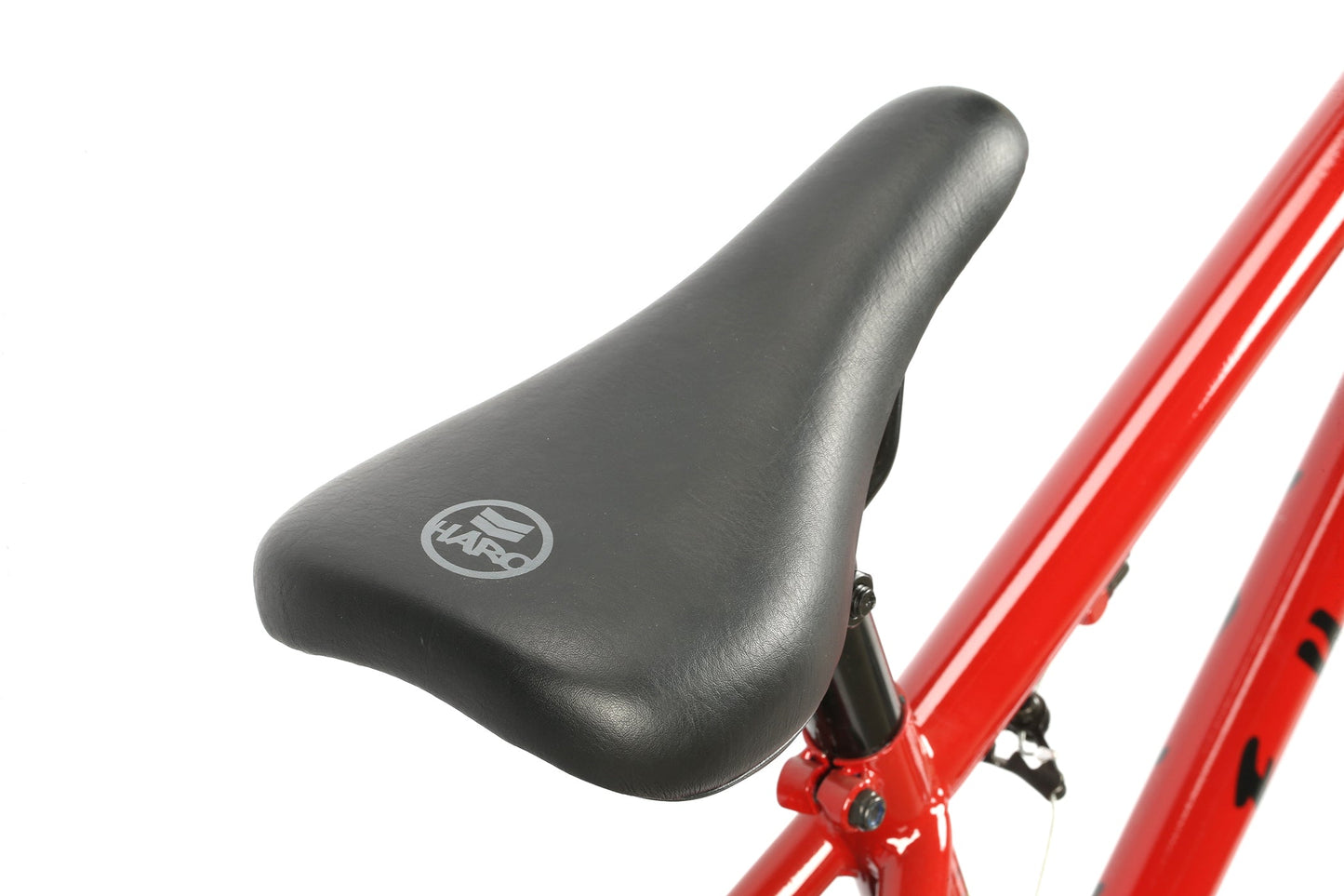 Close-up of a black seat on a red Haro Bikes Leucadia DLX frame, featuring the HARO logo, ideal for Freestyle-BMX lovers.