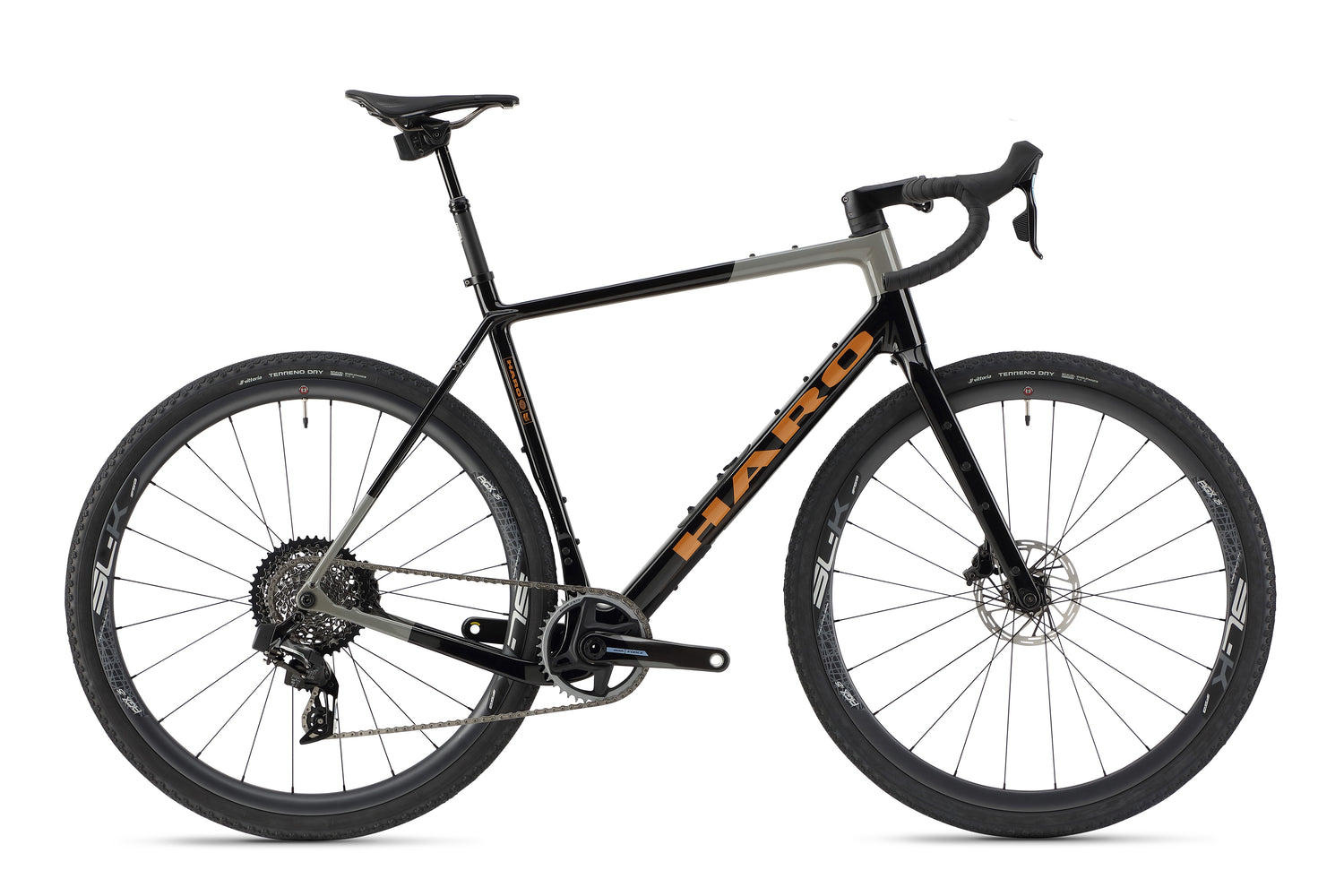 The Buzzard Carbon Top Shelf by Haro Bikes is a sleek black and gray road bike featuring a sturdy carbon frame, drop handlebars, disc brakes, SRAM Force gear set for various terrains, Gravel-Reifen for traction, black wheels, and a comfortable saddle with the brand name in orange.