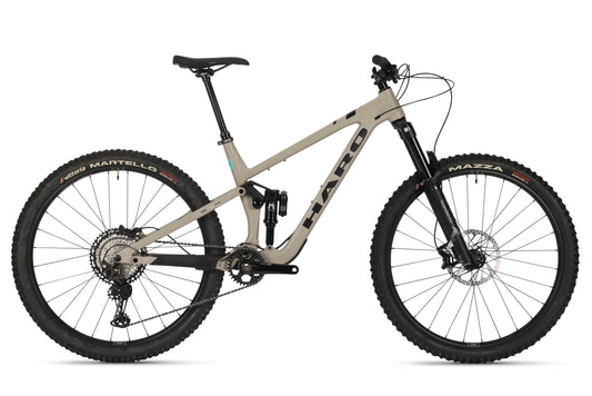 The Daley Alloy 1 by Haro Bikes is a sleek trail bike with a beige frame and black components, including gears, handlebars, and tires. The brand is displayed on the aluminiumrahmen, and it features disc brakes and a suspension system for superior performance on rugged terrains.