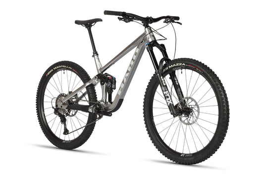 The Daley Alloy LTD 2 by Haro Bikes is a sleek silver full-suspension mountain bike with thick tires and disc brakes, featuring a modern frame. Displayed at an angle, it highlights its Fox Suspension system with front fork and rear suspension.