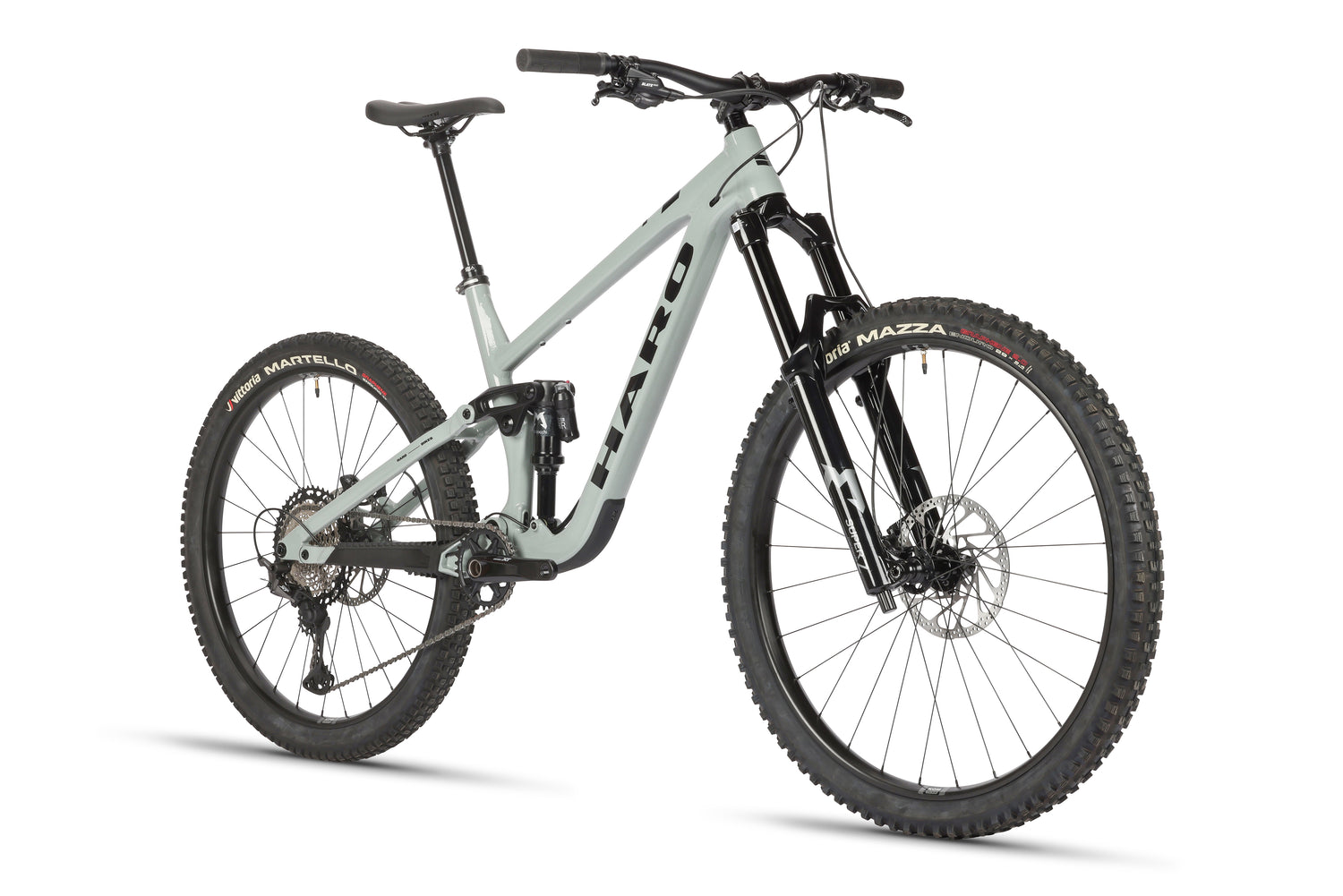 The Haro Bikes Greer Alloy 1 is a sleek, modern gray mountain bike featuring an Alloy Greer-Rahmen, mullet Radkonfiguration, thick knobby tires, front and rear suspension with progressive Federung, disc brakes, and a comfortable saddle—ideal for off-road cycling adventures.