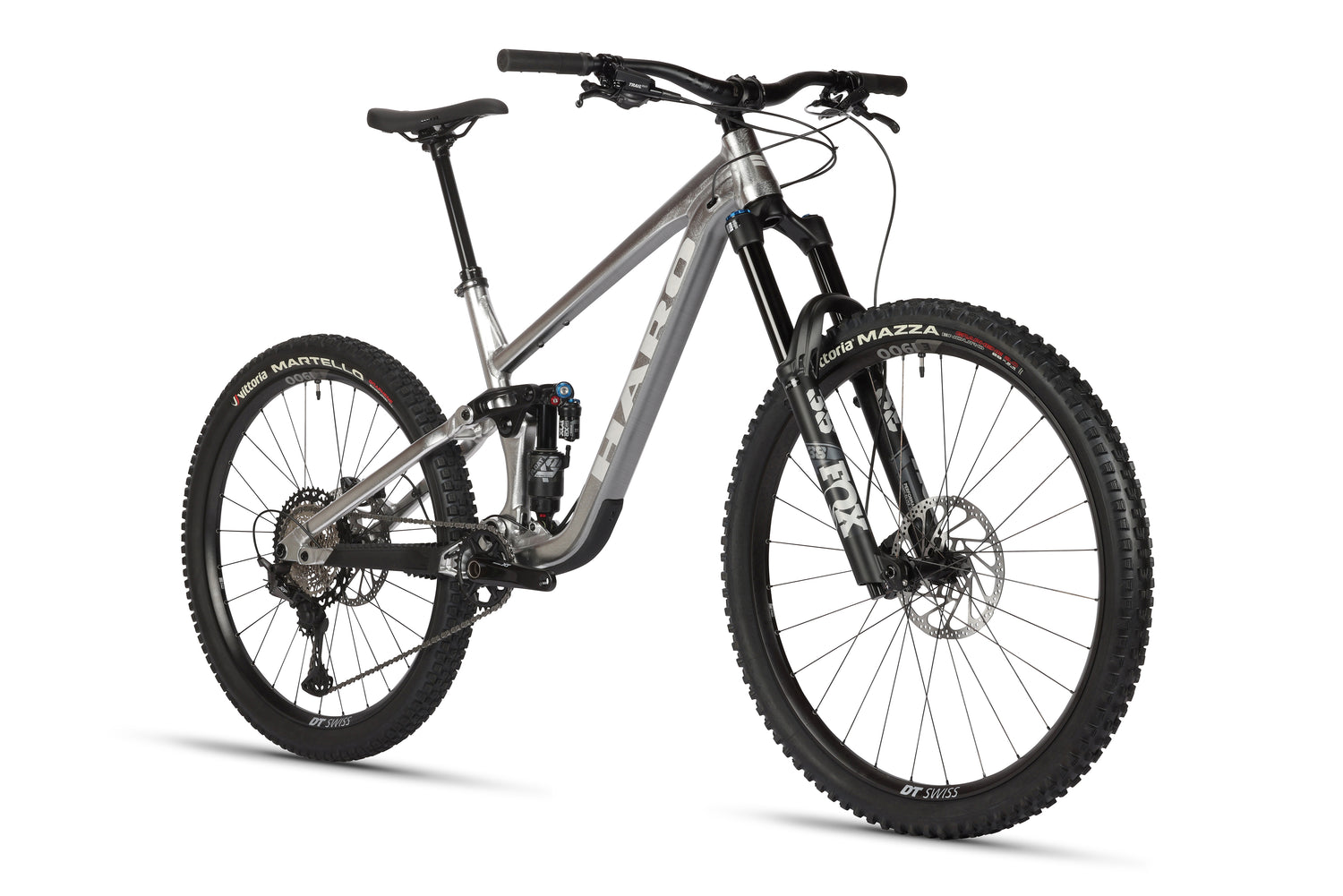 The Haro Bikes Greer Alloy LTD 2 is a sleek gray mountain bike with a raw aluminum frame, thick tires, Fox suspension, and disc brakes. It features a comfortable seat and wide handlebars designed for peak off-road cycling performance.