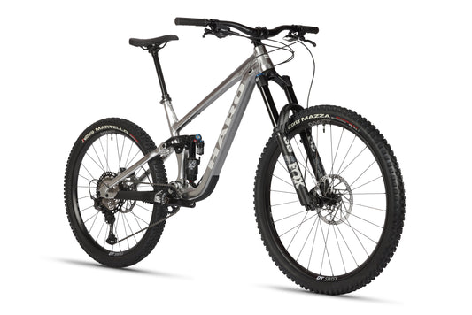 The Haro Bikes Greer Alloy LTD 2 is a sleek gray mountain bike with a raw aluminum frame, thick tires, Fox suspension, and disc brakes. It features a comfortable seat and wide handlebars designed for peak off-road cycling performance.
