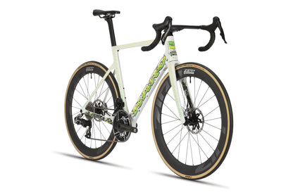 The Rivette Carbon LTD by Haro Bikes is a modern racing bicycle with a white frame and green accents, drop handlebars, Zipp wheels with disc brakes, sleek aerodynamics, tan wall tires, and it is a limited edition by Mark Ward presented at an angle.