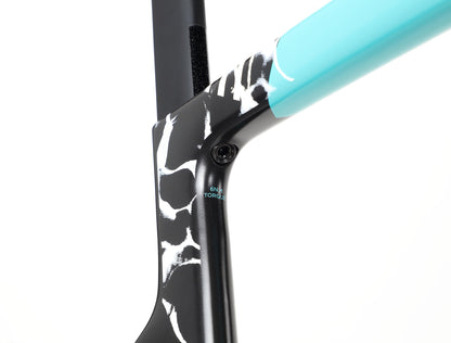 Close-up of the Rivette Carbon 2 by Haro Bikes, a race-ready road bike frame with a sleek design, featuring a black and white patterned lower section, turquoise upper section, and visible 6Nm Torque screw at the frame junction. Its streamlined look is enhanced by internal cable routing.