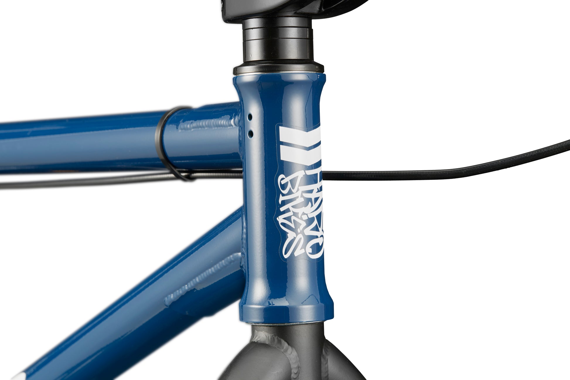 Close-up of a blue Haro Bikes Downtown 24’s front frame with white STYX logo, black cables, and part of the handlebar stem visible.