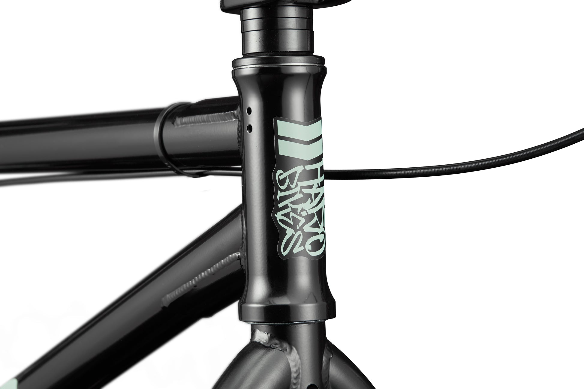 Close-up of a versatile Haro Bikes Downtown 24 BMX frame in black with light green logo, front brake cable, and 24" wheels.