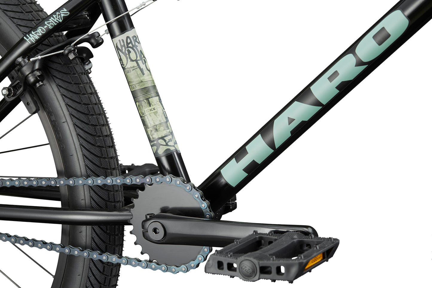 Close-up of a versatile Haro Bikes Downtown 24 BMX frame, showing the pedal, chain, rear wheel, and 24" wheels.