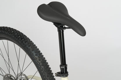 Close-up of a black bicycle seat and rear wheel from the Haro Bikes Double Peak 1 against a plain white background.