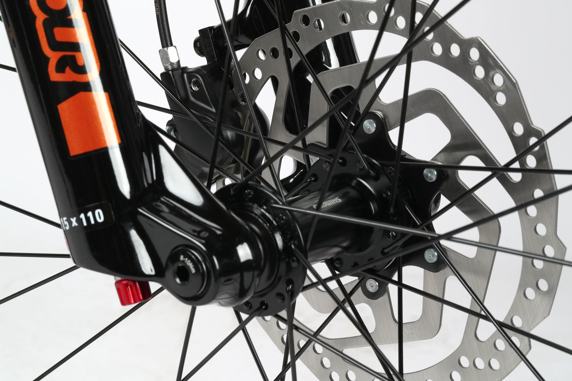 Close-up of Double Peak 2s front disc brakes and spokes, showcasing a black fork with orange decals by Haro Bikes.