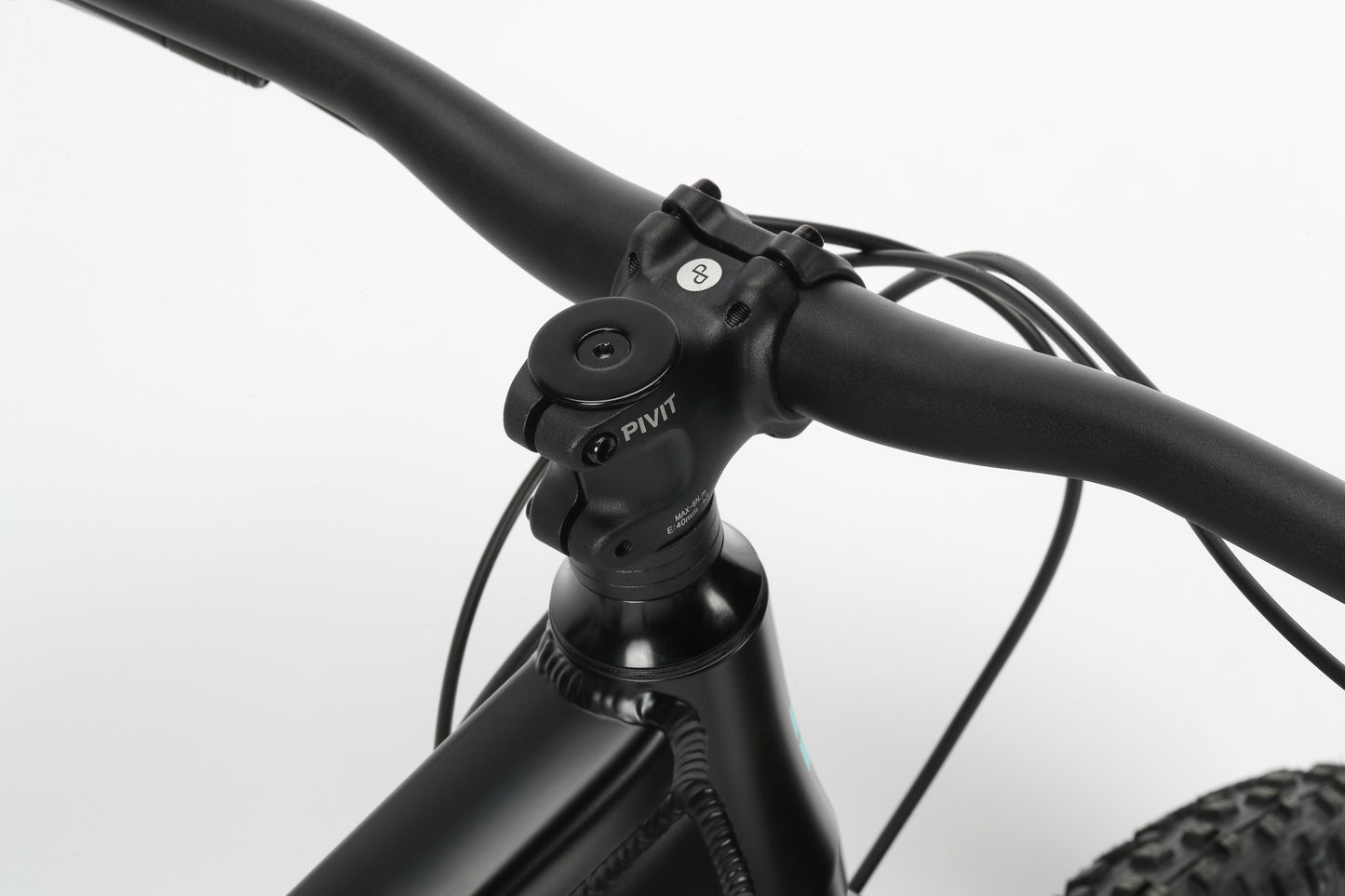 Close-up of Haro Bikes Double Peak 3 handlebar and stem with cables, in black matte against a plain white background.