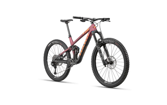 The Haro Bikes Daley Carbon 1 is a modern full-suspension All-Mountain bike with thick tires and a matte maroon and black frame.