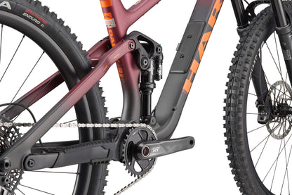 Close-up of the Daley Carbon 1’s rear suspension, crankset, and rugged tire by Haro Bikes showcasing detailed components.