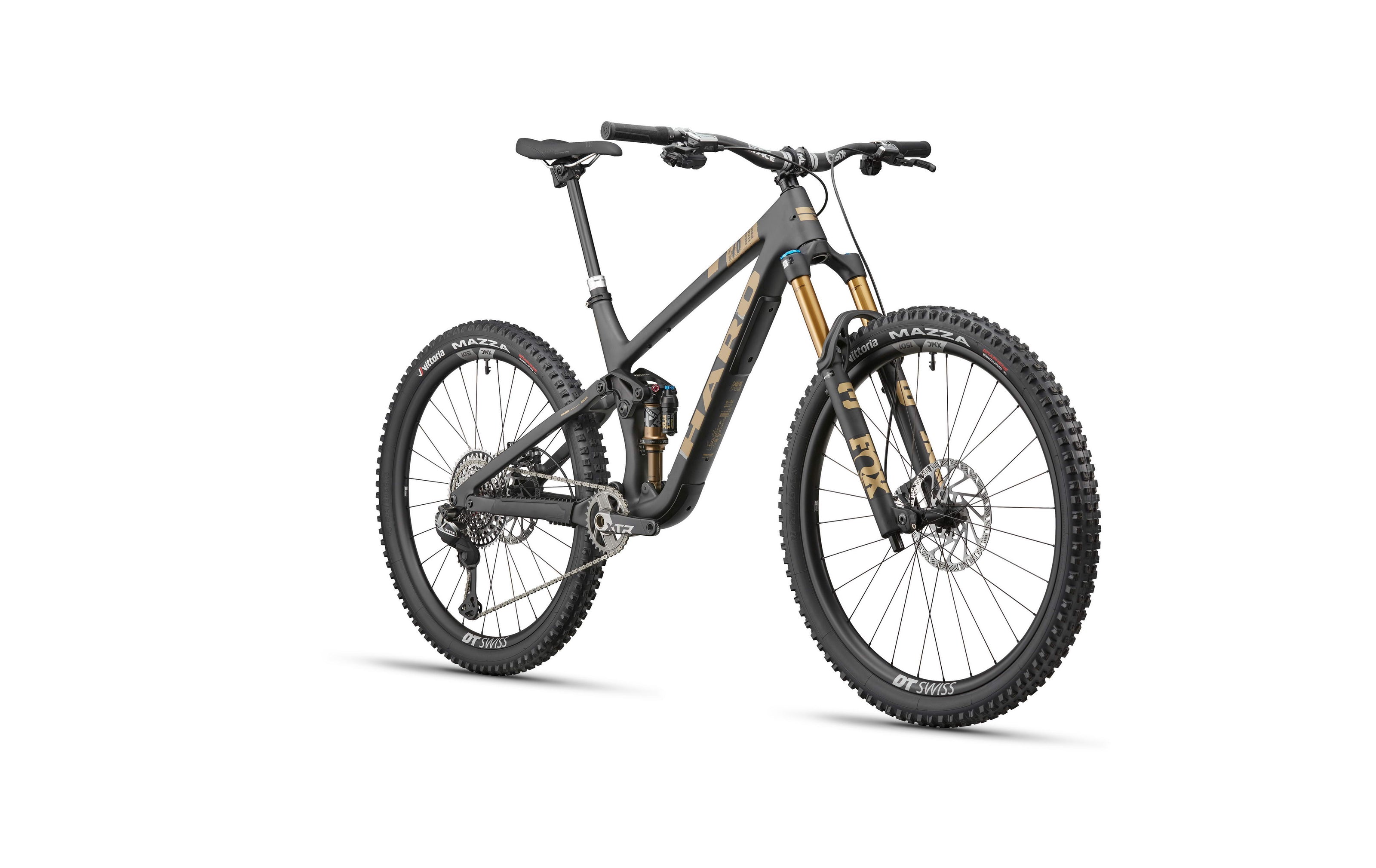 The HARO Daley Carbon Top Shelf is a black and gold all-mountain carbon bike with wide tires and disc brakes on a white background.