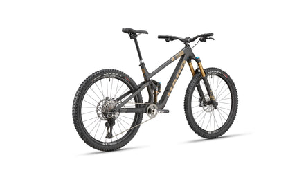 The HARO Daley Carbon Top Shelf is a modern all-mountain bike with thick tires, disc brakes, and a dark frame seen from the rear side.