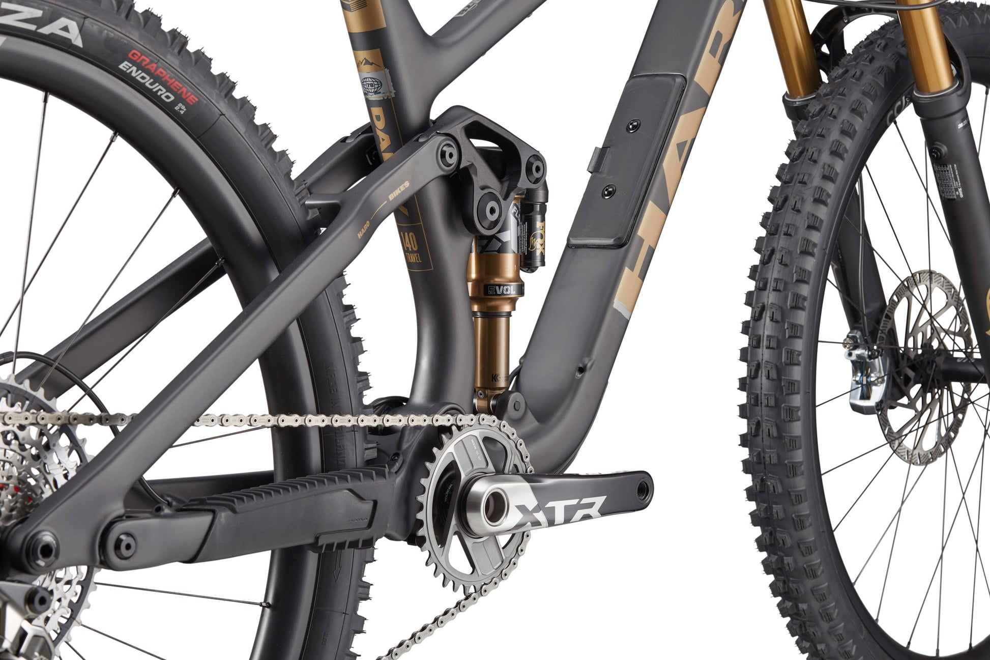 Close-up of the Haro Bikes Daley Carbon Top Shelf’s frame, rear suspension, chainring, and front of the rear tire.