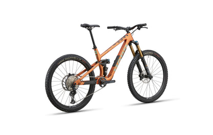 The Haro Bikes Greer Carbon 2 enduro bike in orange with black tires and seat, shown at a three-quarter angle on white.
