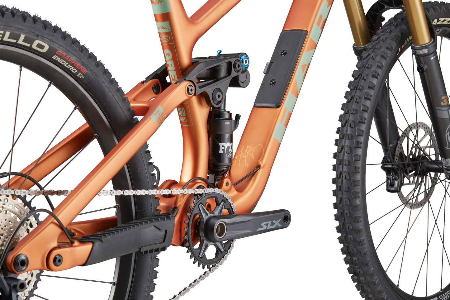 Close-up of the Haro Bikes Greer Carbon 2 frame, Shimano SLX drivetrain, rear suspension, front wheel, and fork.
