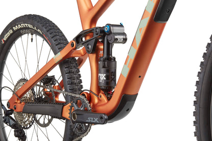 Close-up of the Haro Bikes Greer Carbon 2 enduro frame, highlighting crankset, rear suspension, and rear wheel.