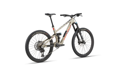 The Haro Bikes Greer Carbon 3 is a beige/black enduro bike with thick tires, disc brakes, and Trail Agilität from a rear view.