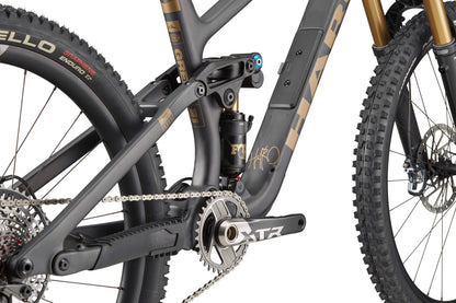 Close-up of Haro Bikes’ Greer Carbon Top Shelf frame, Fox 38-Float-Factory fork, chain, gears & Pirelli tire on a carbon MTB.