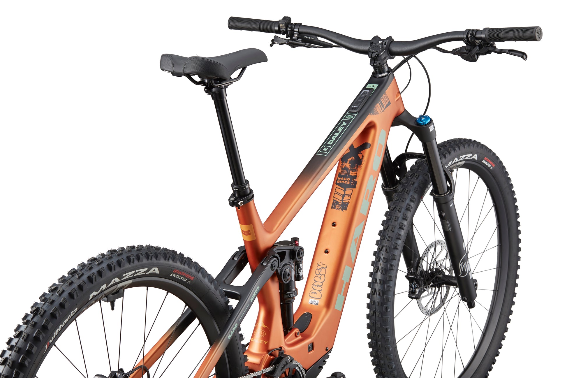 Haro Bikes eDaley Carbon 2 full-suspension mountain bike in orange and black, rear side view highlights frame, tires, and handlebars.