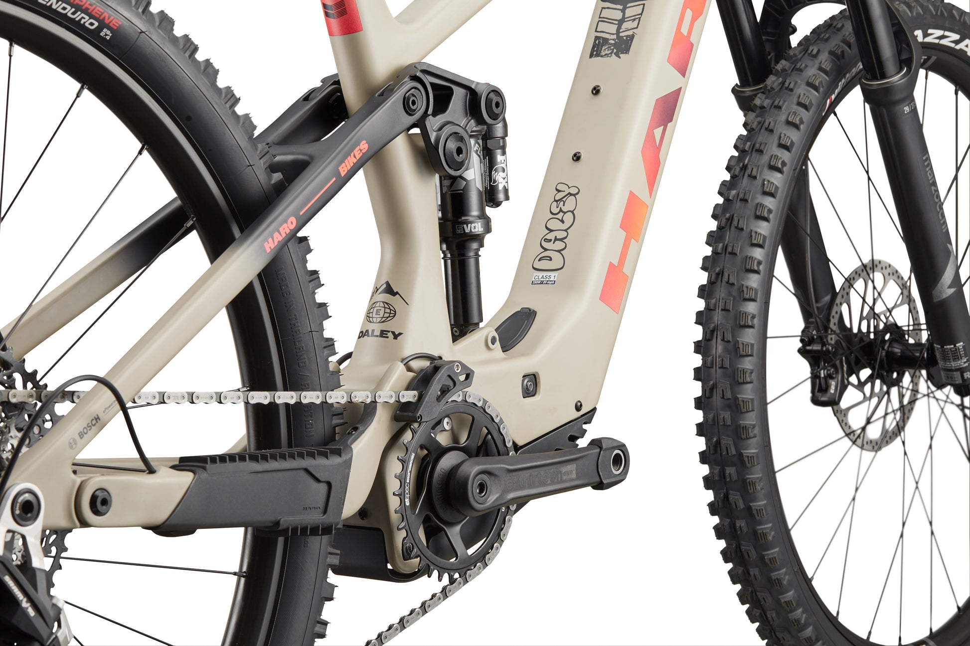 Close-up of a Haro Bikes eDaley Carbon 3 midsection and drivetrain, featuring a beige and black carbon frame.