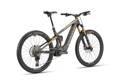 The Haro Bikes eDaley Carbon Top Shelf is a matte black/bronze full-suspension E-MTB with thick tires and disc brakes, rear view.