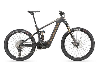 A side view of the Haro Bikes eGreer Carbon Top Shelf E-Bike in black and gold with thick tires, full suspension, and disc brakes.