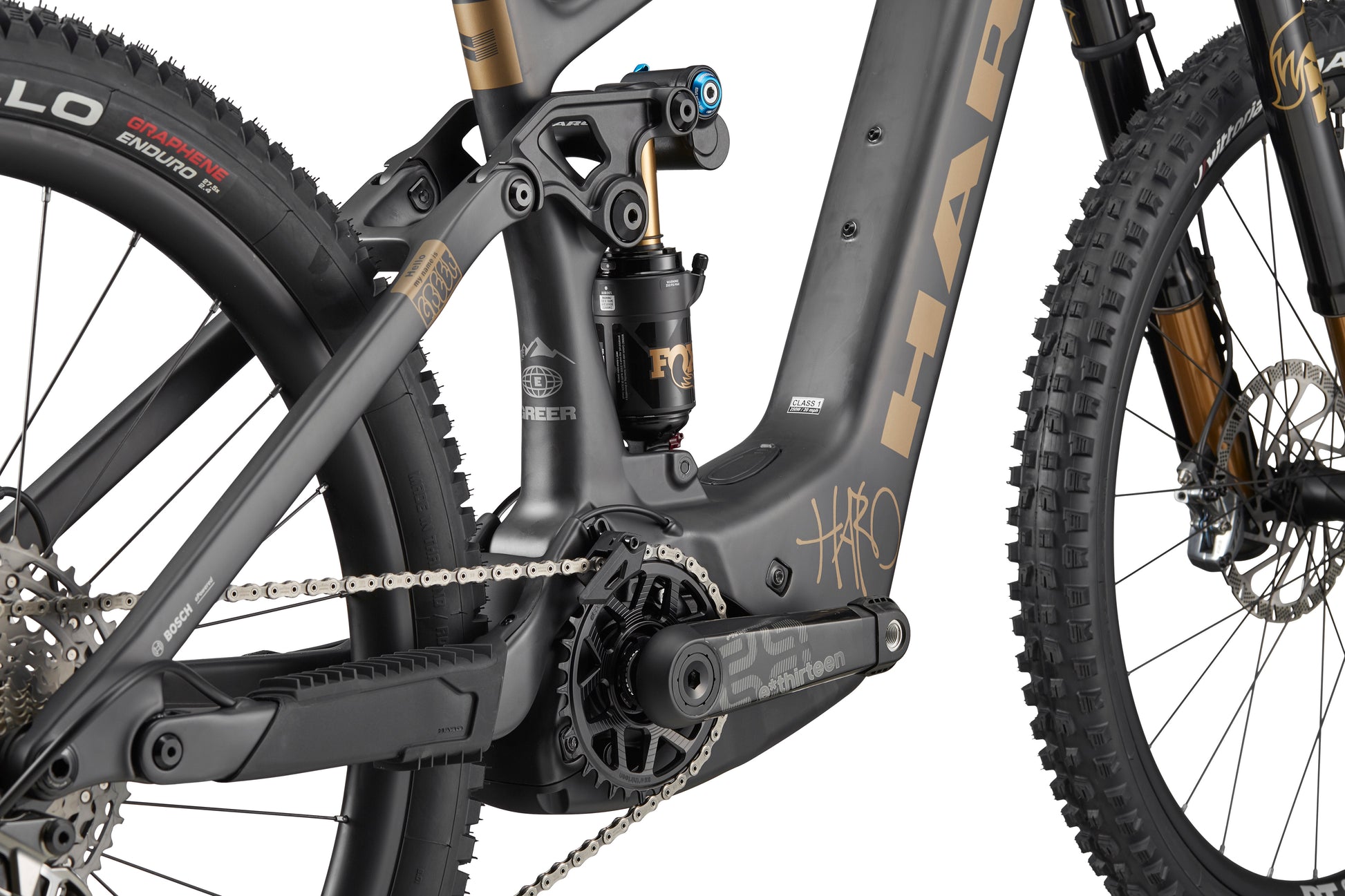 Close-up of Haro Bikes eGreer Carbon Top Shelf’s carbon frame, gears, chain, and Bosch Performance Line CX branding in detail.