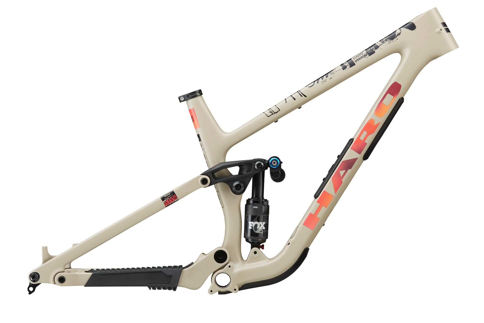 A beige Daley Carbon Frameset from Haro Bikes with orange-red branding and a Fox rear shock absorber attached.
