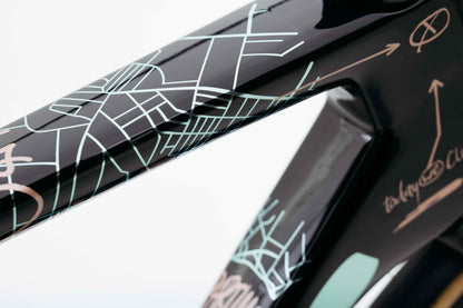 Close-up of Haro Bikes Partimos Carbon Custom "Grid" frame, with abstract city map art on glossy black carbon surface.