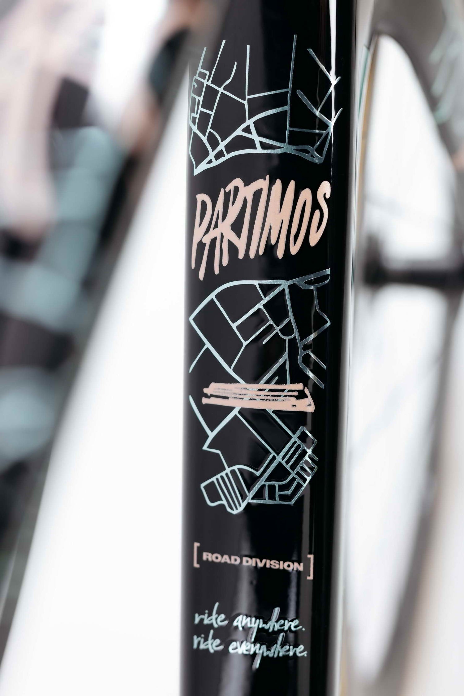 A close-up of a Haro Bikes Partimos Carbon Custom "Grid" frame shows map graphics, “PARTIMOS GRID”, and “ride anywhere. ride everywhere.”.