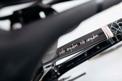 Close-up of a Haro Bikes Partimos Carbon Custom "Grid" frame with ride anywhere. ride everywhere. in white script.