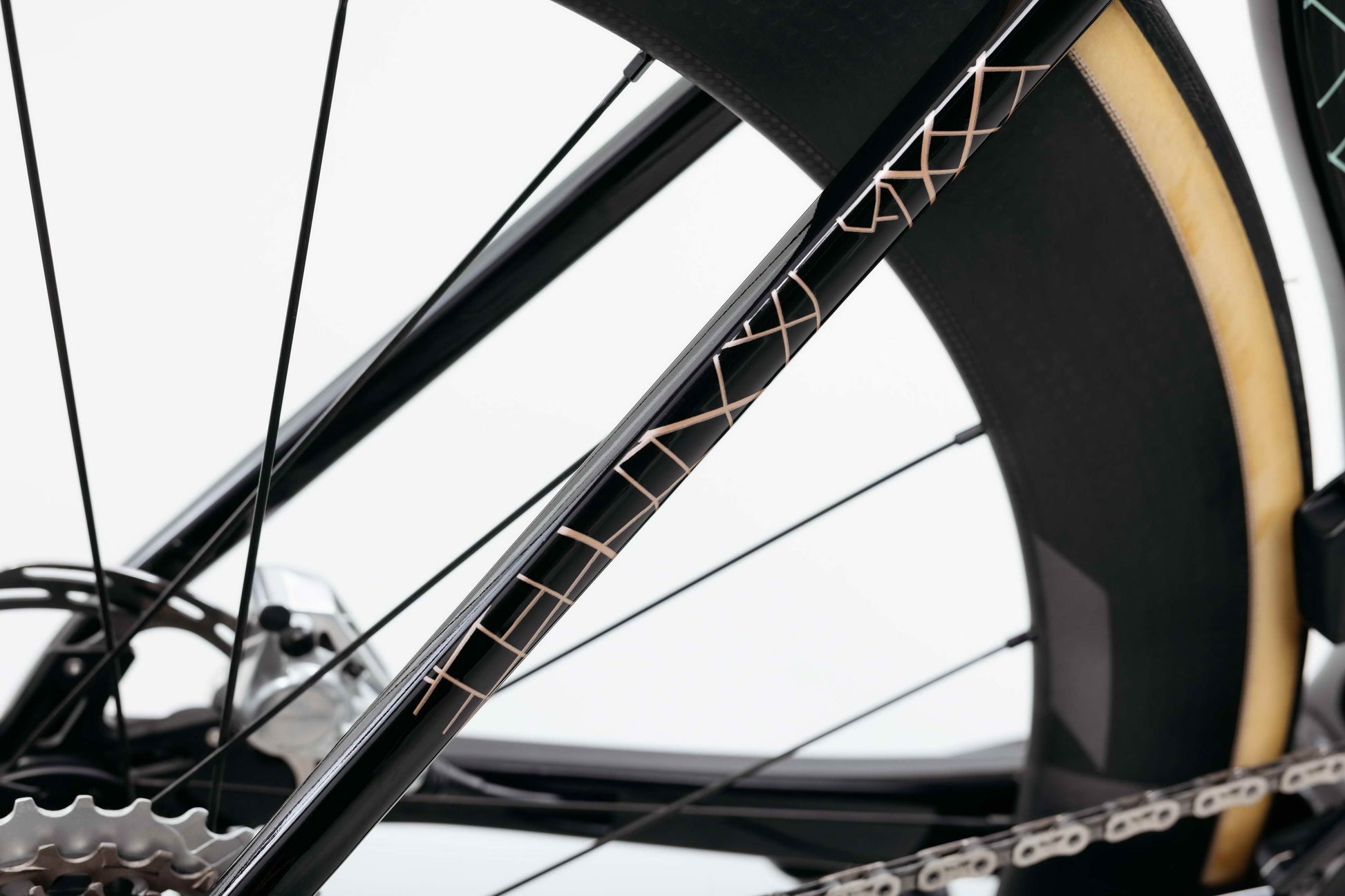 Close-up of Haro Bikes' Partimos Carbon Custom "Grid"—sleek black/gold frame, thin lines, and detailed rear gears.