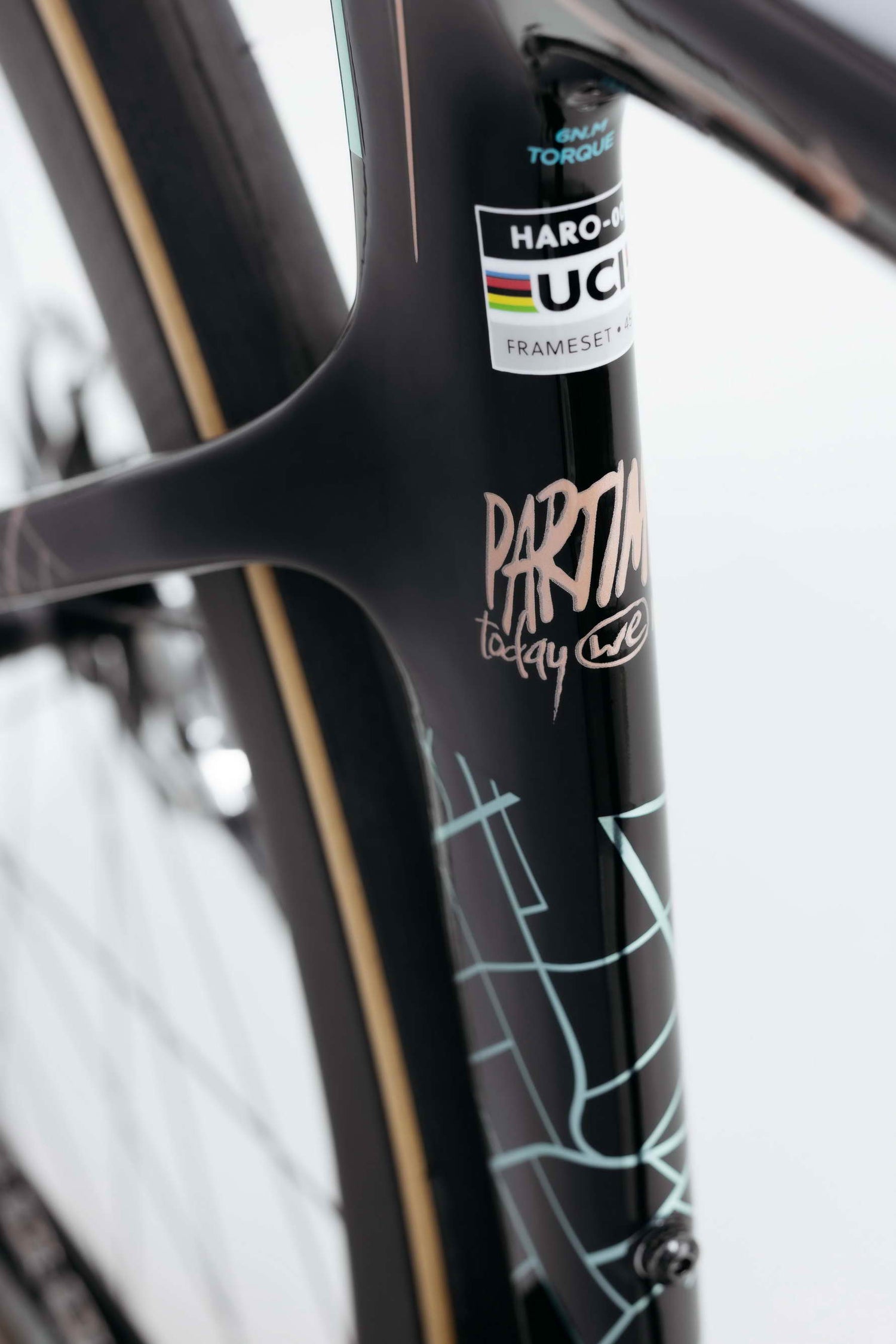Close-up of a black Haro Bikes Partimos Carbon Custom "Grid" frame with UCI sticker and abstract white line designs.