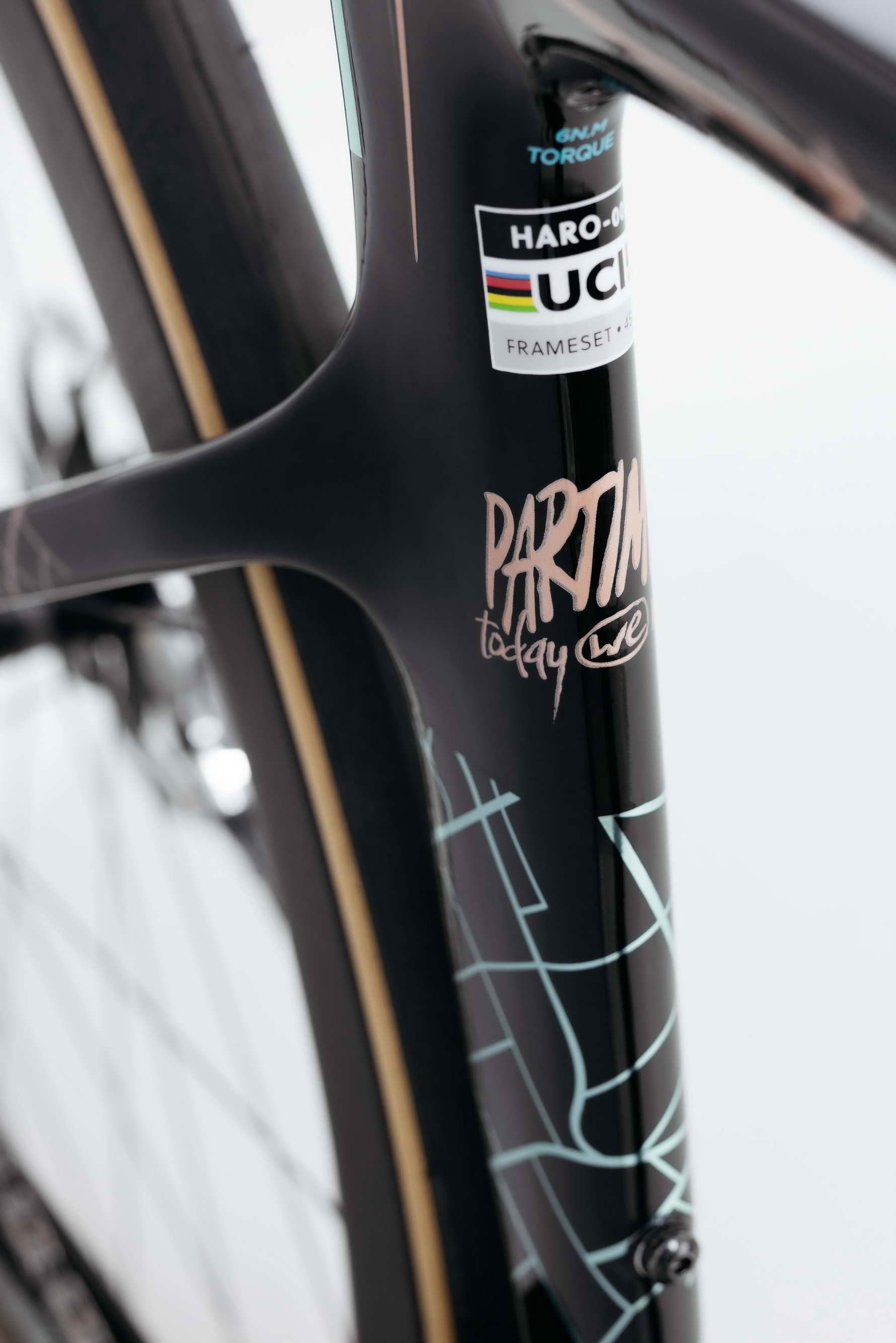 Close-up of a black Haro Bikes Partimos Carbon Custom "Grid" frame with UCI sticker and abstract white line designs.