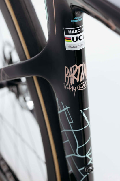 Close-up of a black Haro Bikes Partimos Carbon Custom "Grid" frame with UCI sticker and abstract white line designs.