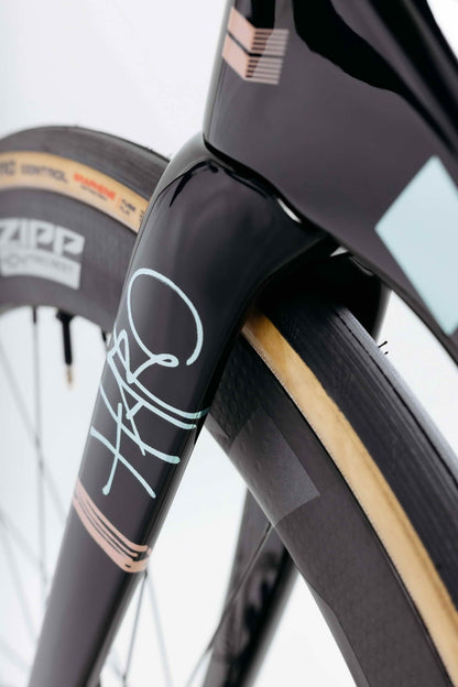 Close-up of a Haro Bikes Partimos Carbon Custom "Grid" front fork and tire, showcasing its signature and GRID branding.