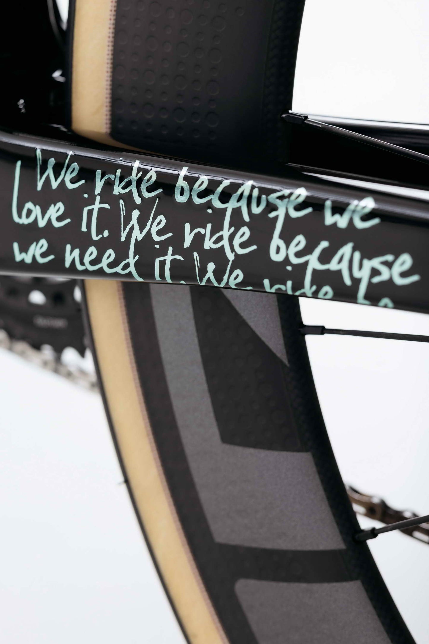 Close-up of a Haro Bikes Partimos Carbon Custom "Grid" frame with handwritten text: We ride because we love it. We ride because we need it.